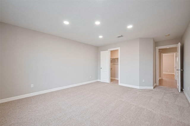 11107 Camino Oaks Dr, Houston, TX 77064 - unfurnished bedroom with light colored carpet, recessed lighting, a walk in closet, and a closet