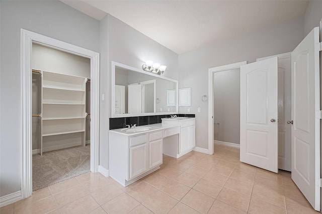 11107 Camino Oaks Dr, Houston, TX 77064 - bathroom featuring tile patterned flooring, double vanity, and a walk in closet