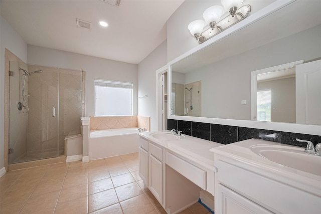 11107 Camino Oaks Dr, Houston, TX 77064 - bathroom with double vanity, a shower stall, a garden tub, tile patterned flooring, and recessed lighting