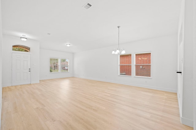 506 Mornington Ln, Katy, TX 77494 - unfurnished living room with a chandelier and light wood-style flooring
