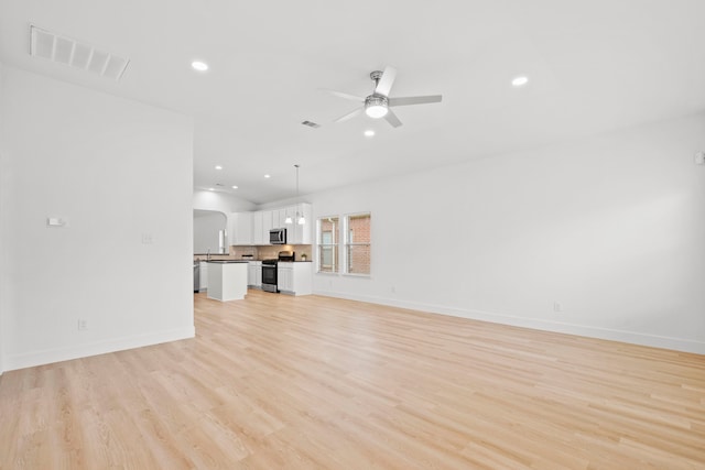 506 Mornington Ln, Katy, TX 77494 - unfurnished living room with ceiling fan, light wood finished floors, recessed lighting, and lofted ceiling