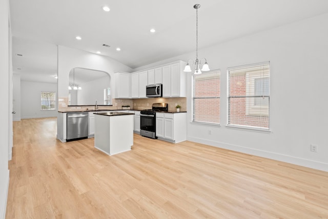 506 Mornington Ln, Katy, TX 77494 - kitchen with appliances with stainless steel finishes, a chandelier, dark countertops, decorative backsplash, and white cabinets