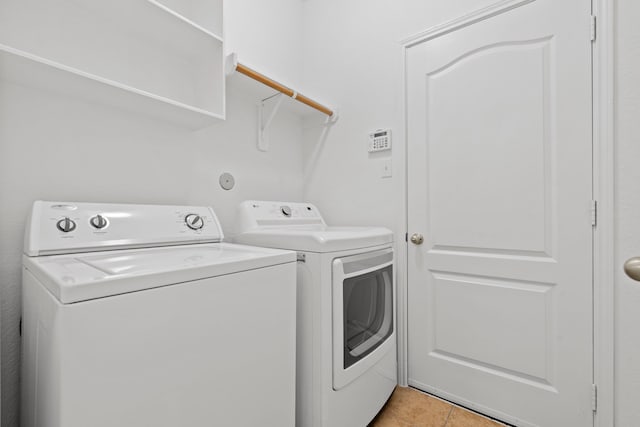 506 Mornington Ln, Katy, TX 77494 - laundry area with washing machine and clothes dryer and light tile patterned floors