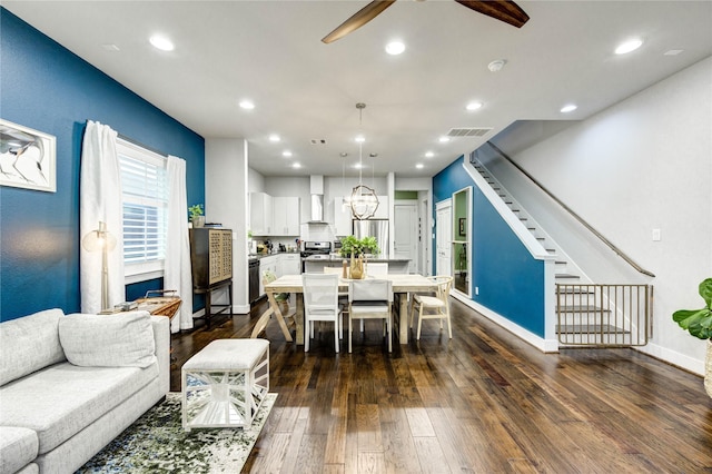 2013 Schweikhardt St, Houston, TX 77020 - dining area with a ceiling fan, dark wood-style floors, stairs, recessed lighting, and a chandelier