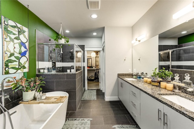 2013 Schweikhardt St, Houston, TX 77020 - full bath featuring a shower stall, a soaking tub, double vanity, tile patterned floors, and recessed lighting