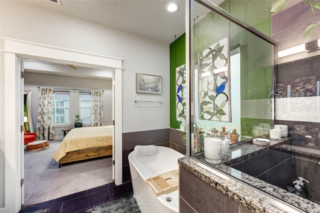2013 Schweikhardt St, Houston, TX 77020 - bathroom featuring a freestanding tub, connected bathroom, recessed lighting, an enclosed shower, and tile walls