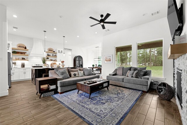 960 Rd 6609, Dayton, TX 77535 - living area featuring a ceiling fan, light wood-style floors, a fireplace, and recessed lighting