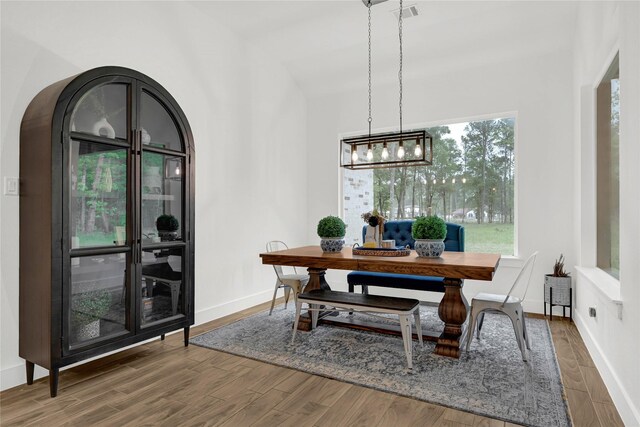 960 Rd 6609, Dayton, TX 77535 - dining area featuring wood finished floors, a chandelier, vaulted ceiling, and arched walkways