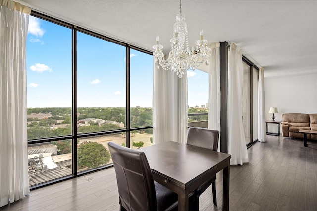 1111 Bering Dr Unit 805, Houston, TX 77057 - dining room with a chandelier, a wall of windows, and wood finished floors