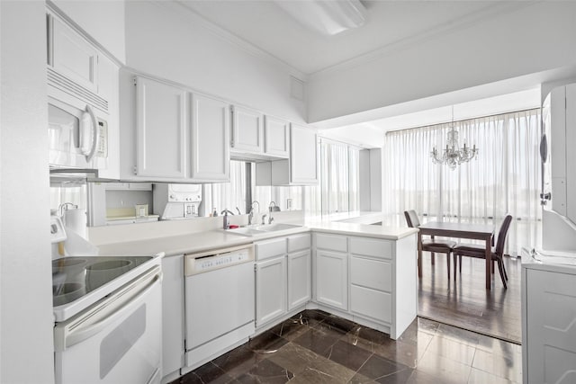 1111 Bering Dr Unit 805, Houston, TX 77057 - kitchen with white appliances, crown molding, a chandelier, a peninsula, and light countertops
