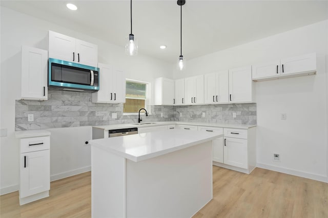 7504 Laura Koppe Rd C/D, Unit C/D Houston, TX 77028 - kitchen featuring appliances with stainless steel finishes, decorative backsplash, light wood-style floors, white cabinetry, and recessed lighting