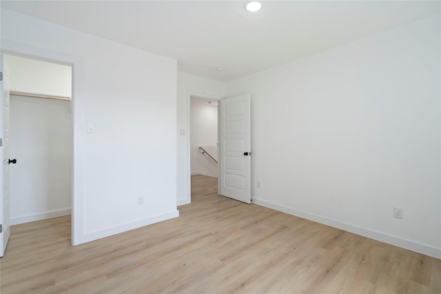 7504 Laura Koppe Rd C/D, Unit C/D Houston, TX 77028 - unfurnished bedroom with light wood-style flooring, a spacious closet, a closet, and recessed lighting