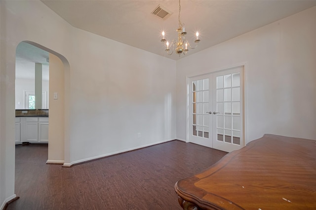 619 Bending Bough Dr, Spring, TX 77388 - unfurnished dining area with arched walkways, dark wood-style flooring, a chandelier, and french doors