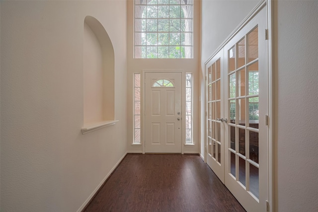 619 Bending Bough Dr, Spring, TX 77388 - entryway featuring dark wood-style floors, french doors, arched walkways, and a towering ceiling