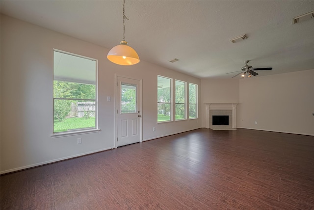 619 Bending Bough Dr, Spring, TX 77388 - unfurnished living room featuring healthy amount of natural light, dark wood-style floors, and a premium fireplace