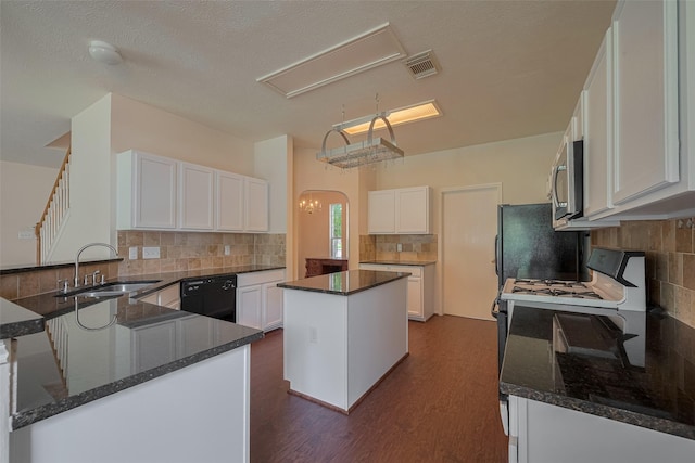 619 Bending Bough Dr, Spring, TX 77388 - kitchen with black appliances, backsplash, dark stone counters, and white cabinetry