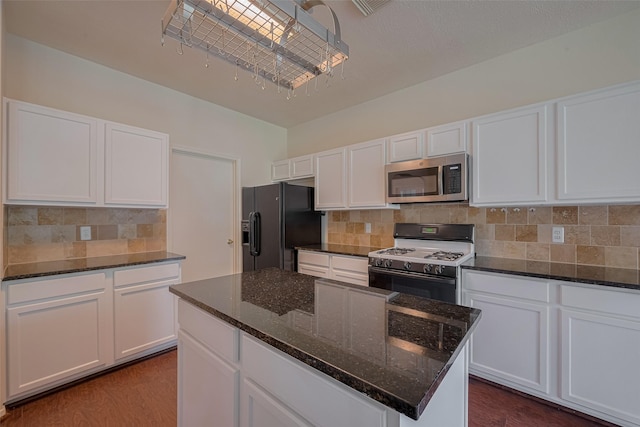 619 Bending Bough Dr, Spring, TX 77388 - kitchen featuring stainless steel microwave, white range with gas stovetop, black refrigerator with ice dispenser, and white cabinets