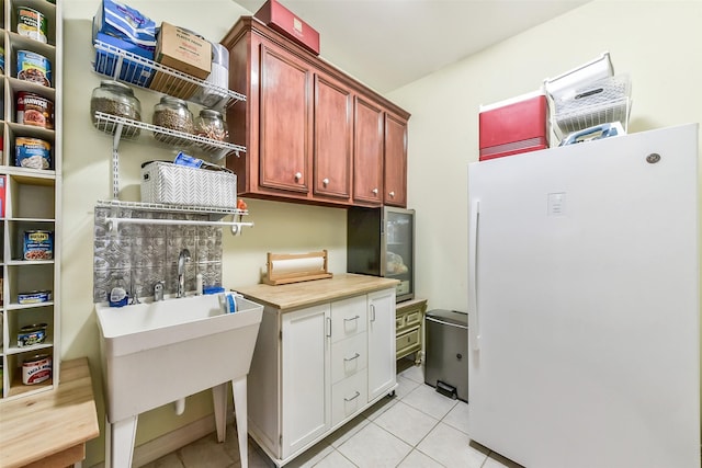 19426 Indigo Lake Dr, Magnolia, TX 77355 - laundry area featuring light tile patterned floors