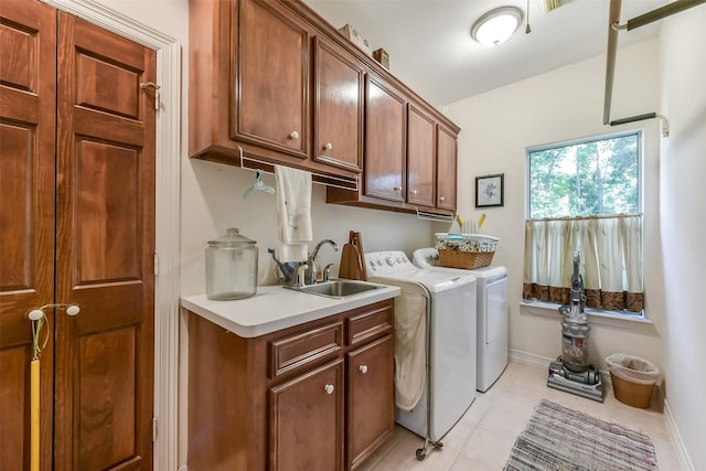 19426 Indigo Lake Dr, Magnolia, TX 77355 - laundry area featuring cabinet space, separate washer and dryer, and light tile patterned floors