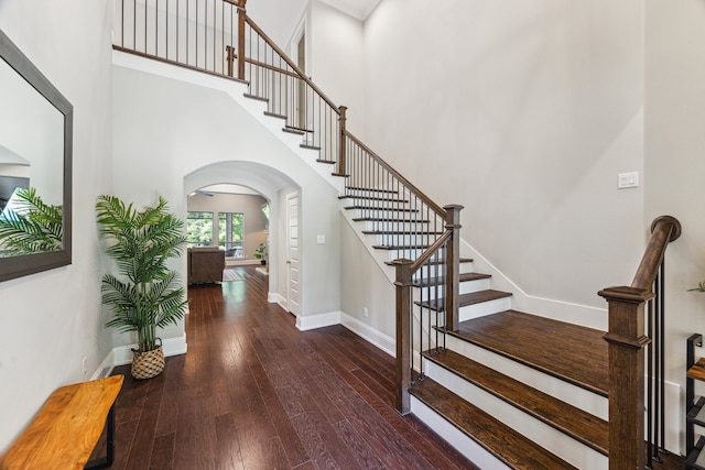 27016 Hidden Grove Landing Dr, Spring, TX 77386 - stairs with arched walkways, hardwood / wood-style floors, and a towering ceiling
