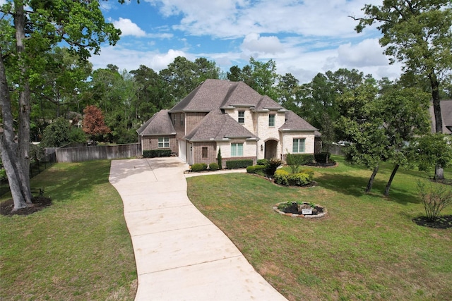 27016 Hidden Grove Landing Dr, Spring, TX 77386 - french country inspired facade with concrete driveway, brick siding, roof with shingles, and a garage