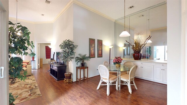 3011 Flower Field Ln, Pearland, TX 77584 - dining space featuring wood finished floors, ornamental molding, and a high ceiling