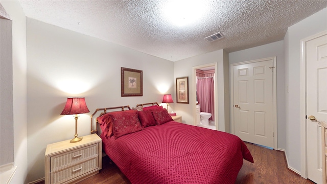 3011 Flower Field Ln, Pearland, TX 77584 - bedroom featuring wood finished floors, a textured ceiling, and ensuite bathroom