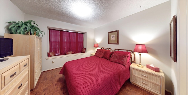 3011 Flower Field Ln, Pearland, TX 77584 - bedroom featuring dark wood-type flooring and a textured ceiling