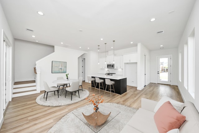 105 Frawley St, Houston, TX 77009 - living area featuring light wood-type flooring, recessed lighting, and stairs