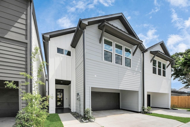 105 Frawley St, Houston, TX 77009 - view of front of property with an attached garage, board and batten siding, and concrete driveway
