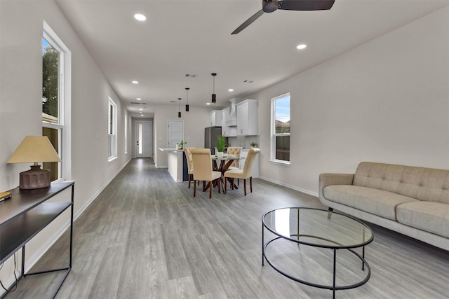 2413 Harlem St, Houston, TX 77020 - living room featuring light wood-style floors, ceiling fan, and recessed lighting