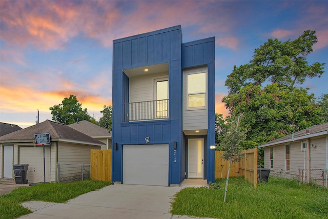 2413 Harlem St, Houston, TX 77020 - view of front facade featuring board and batten siding, concrete driveway, and a garage