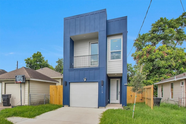 2413 Harlem St, Houston, TX 77020 - view of front facade with board and batten siding, an attached garage, and driveway