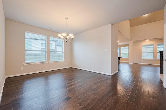 6518 Nicholas Trl, Sugar Land, TX 77479 - spare room with a chandelier and dark wood-type flooring