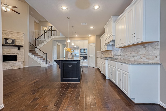 6518 Nicholas Trl, Sugar Land, TX 77479 - kitchen featuring white cabinetry, ceiling fan, light stone countertops, dark wood-style floors, and recessed lighting