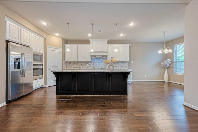 6518 Nicholas Trl, Sugar Land, TX 77479 - kitchen with stainless steel appliances, a chandelier, decorative backsplash, white cabinetry, and dark wood-type flooring