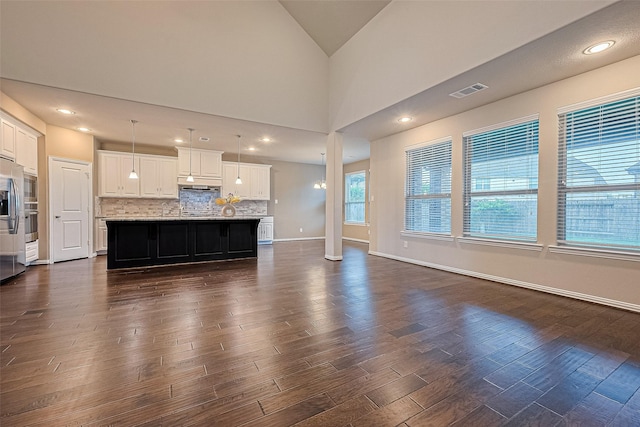 6518 Nicholas Trl, Sugar Land, TX 77479 - unfurnished living room featuring dark wood finished floors and vaulted ceiling