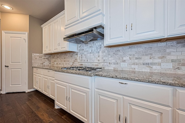 6518 Nicholas Trl, Sugar Land, TX 77479 - kitchen featuring stainless steel gas cooktop, dark wood-style floors, white cabinets, light stone counters, and backsplash