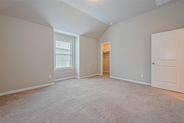 6518 Nicholas Trl, Sugar Land, TX 77479 - unfurnished bedroom with light carpet, vaulted ceiling, and a spacious closet