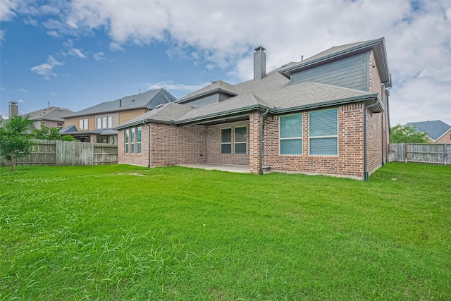 6518 Nicholas Trl, Sugar Land, TX 77479 - rear view of house with brick siding, a fenced backyard, a chimney, a patio, and a shingled roof