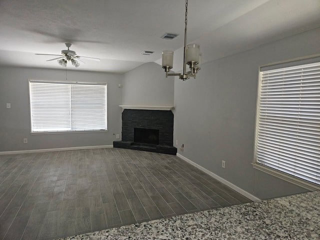7022 Meadow Hawk Ct, Houston, TX 77041 - unfurnished living room featuring a ceiling fan, dark wood-style flooring, a fireplace with raised hearth, and a chandelier