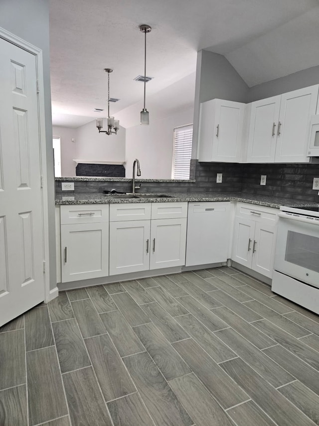 7022 Meadow Hawk Ct, Houston, TX 77041 - kitchen with white appliances, a chandelier, wood tiled floors, white cabinets, and vaulted ceiling