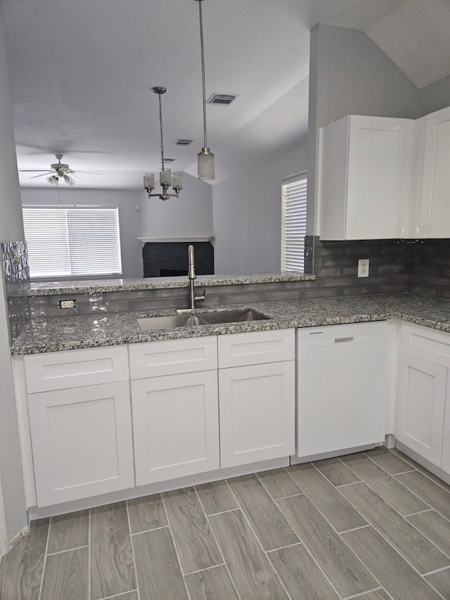 7022 Meadow Hawk Ct, Houston, TX 77041 - kitchen featuring white dishwasher, white cabinets, dark stone countertops, a ceiling fan, and vaulted ceiling