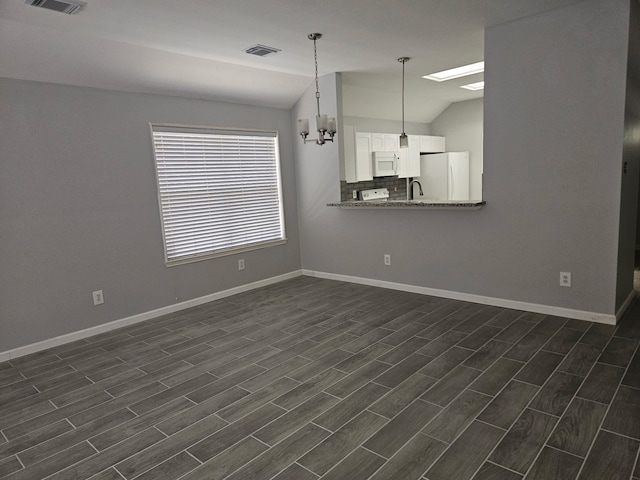 7022 Meadow Hawk Ct, Houston, TX 77041 - empty room featuring lofted ceiling, a chandelier, and dark wood finished floors