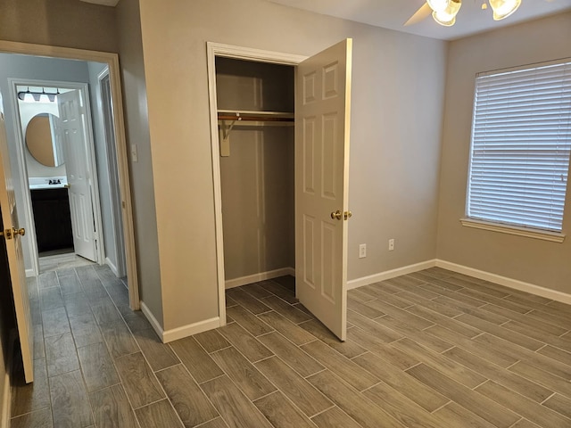 7022 Meadow Hawk Ct, Houston, TX 77041 - unfurnished bedroom with wood tiled floors, a closet, and a ceiling fan