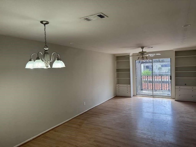 881 Wax Myrtle Ln Unit A, Houston, TX 77079 - spare room featuring wood finished floors, a chandelier, a ceiling fan, and built in shelves