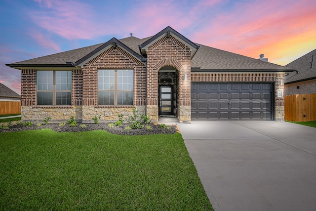 6222 Pelican Ridge Way, League City, TX 77573 - french country inspired facade featuring brick siding, stone siding, concrete driveway, and roof with shingles