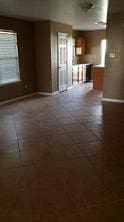 3906 Suttonford Dr, Houston, TX 77066 - unfurnished living room with baseboards