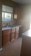 3906 Suttonford Dr, Houston, TX 77066 - kitchen with brown cabinets and light countertops