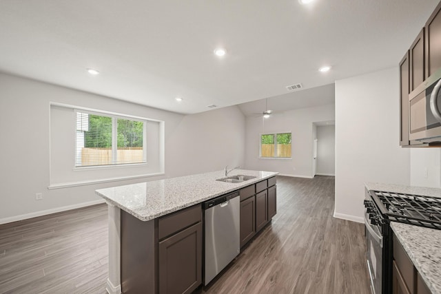 13200 Musky Dr, Conroe, TX 77384 - kitchen with appliances with stainless steel finishes, plenty of natural light, dark wood-style flooring, light stone countertops, and recessed lighting